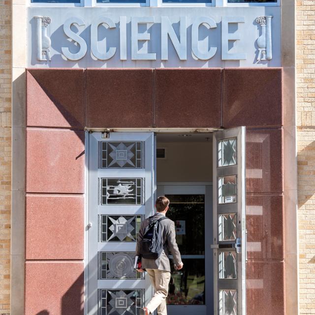 Stundent walkinf into winton scott building
