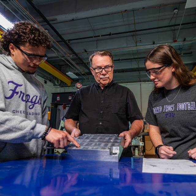 students working on machinery