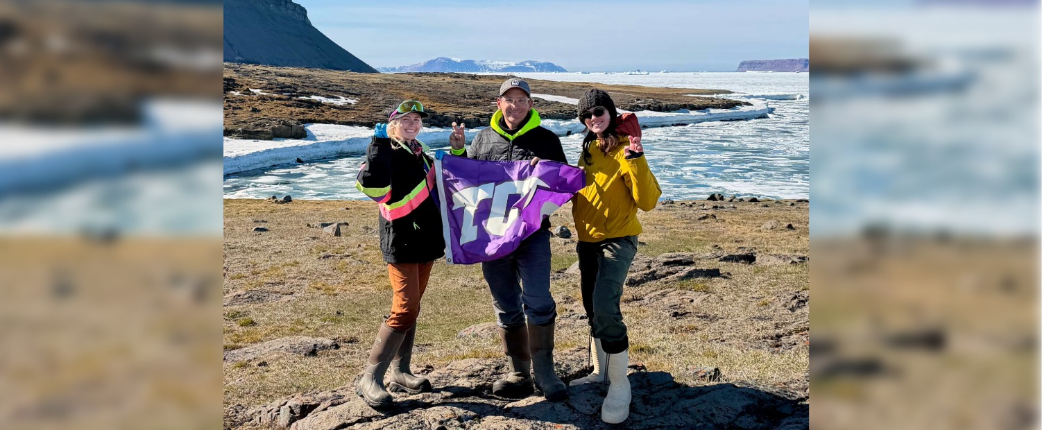 Cami Middlebrooks, Matt Chumchal and Nicole Fordree holding a TCU flag in the arctic
